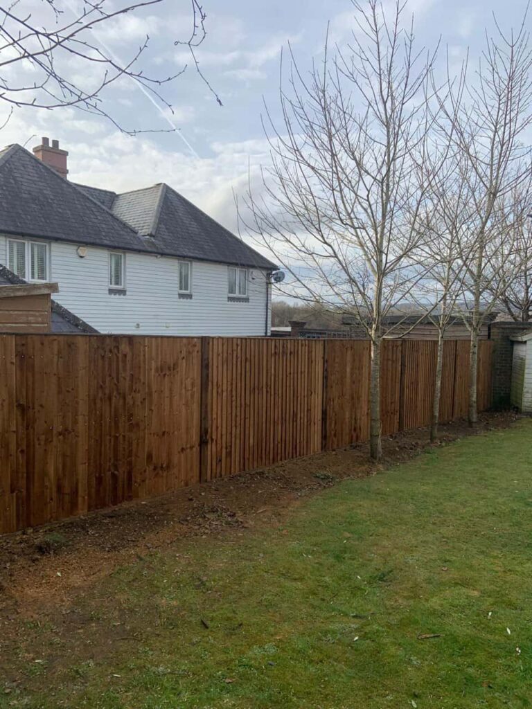 This is a photo of feather edge fencing installed in a residential properties garden by Fast Fix Fencing Moulton